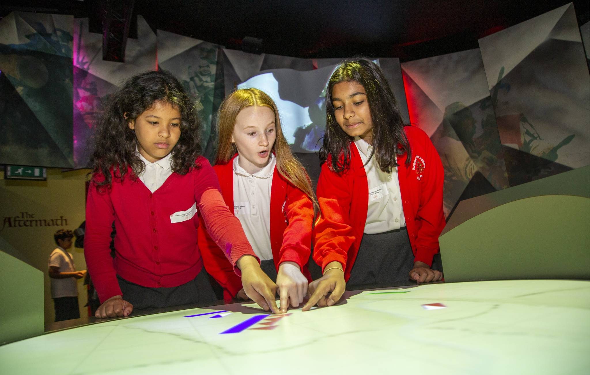 School children looking at interactive exhibit